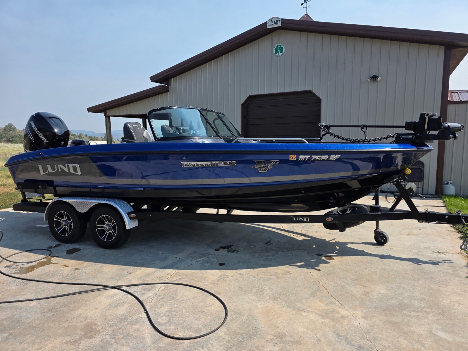 Lund fishing boat cleaned inside and out on its trailer