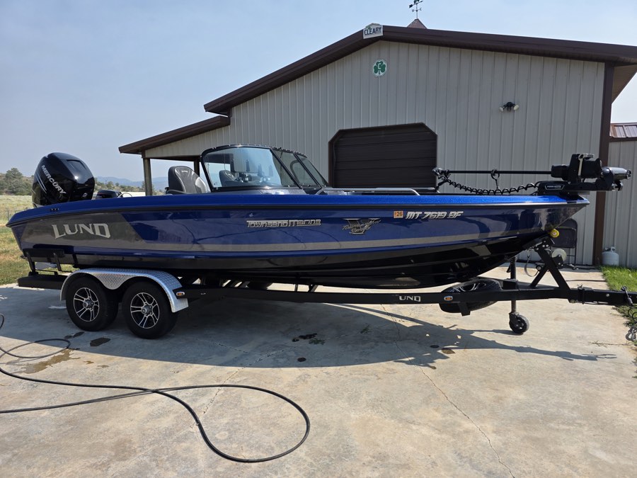 Blue fishing boat cleaned inside and out