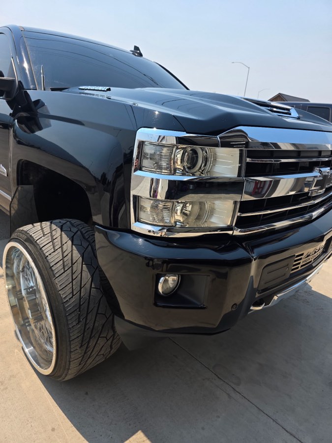 Lifted black Chevrolet Silverado, front three-quarter view after detailing