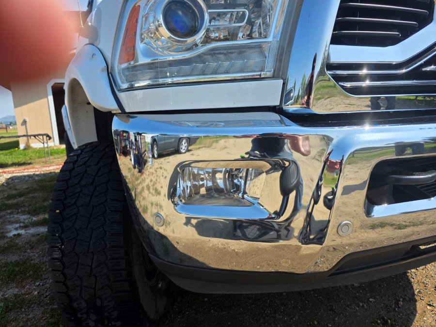 Polished chrome bumper and fog light housing on a Ram truck
