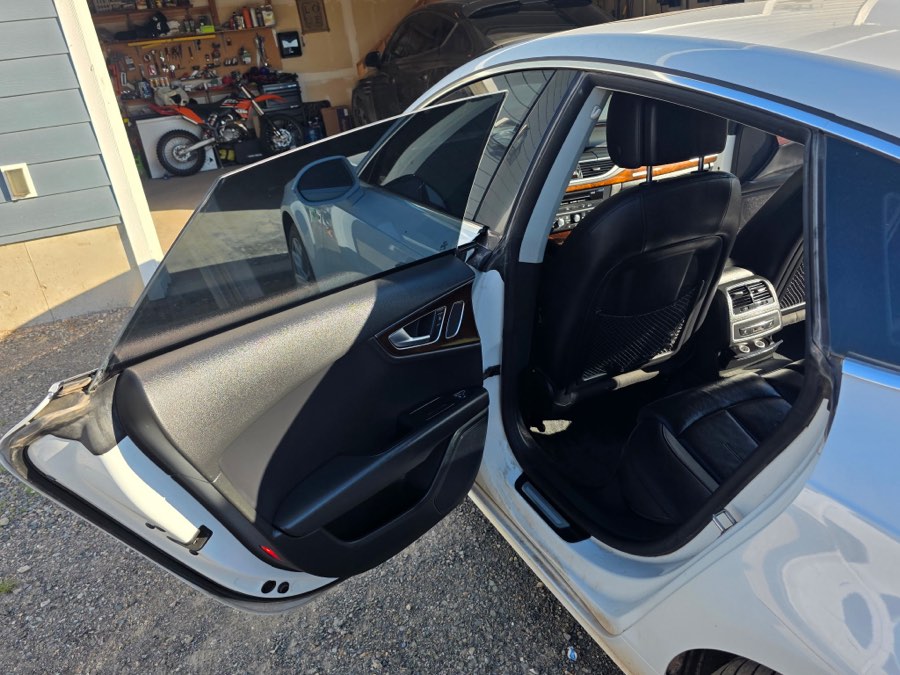 Silver sedan with doors open after a full interior detail