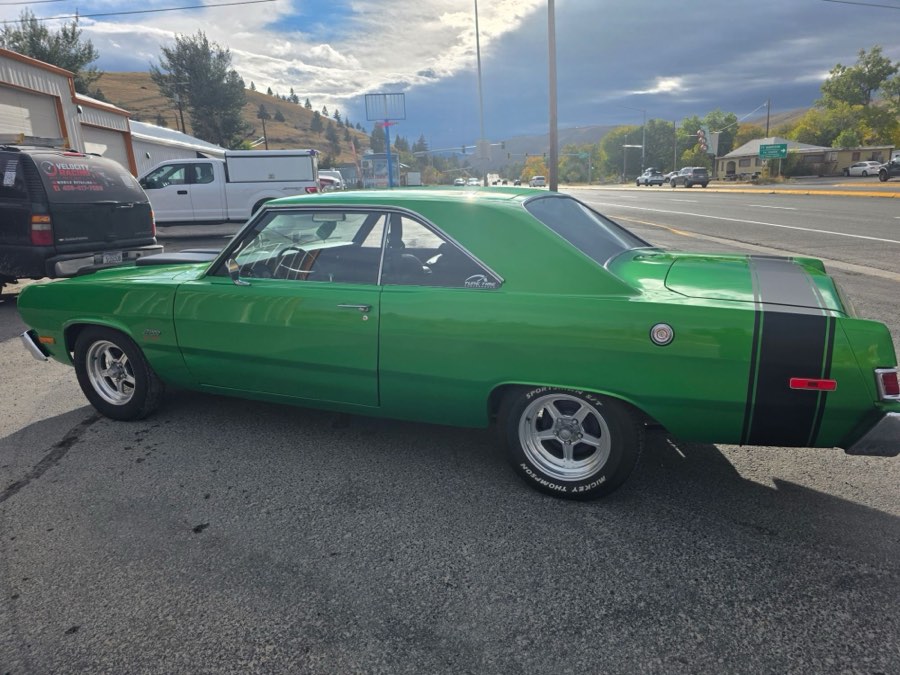 Side profile of a green Plymouth Scamp with a coated, high-gloss finish