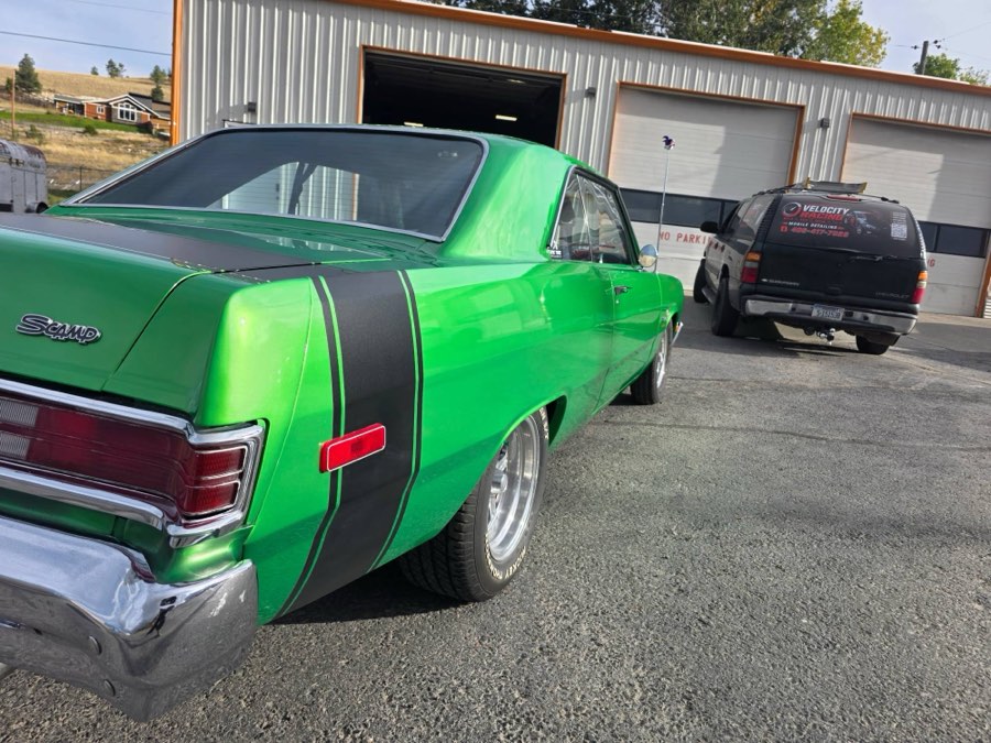 Rear quarter of a ceramic-coated Plymouth Scamp outside the shop