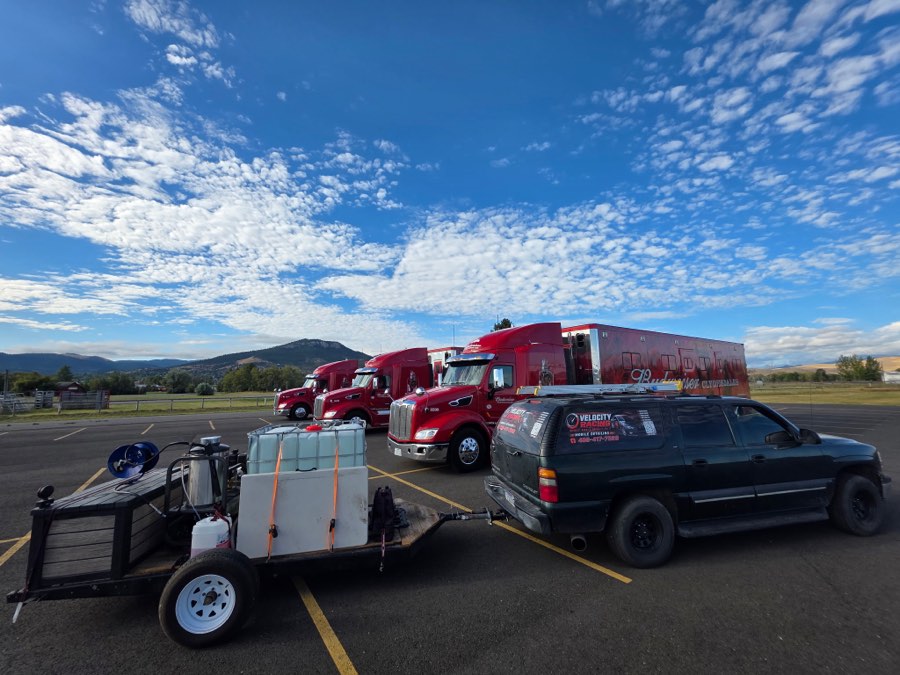 Velocity Racing Suburban and water trailer set up beside the Budweiser Clydesdales tractor-trailers