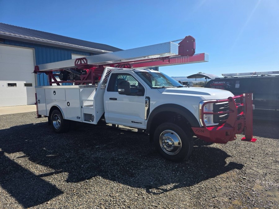 White Ford F-550 pump-hoist service truck detailed outside the shop