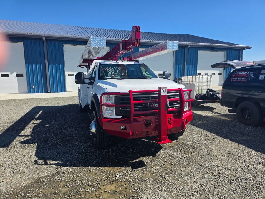 Front of a detailed Ford F-550 service truck with a red grille guard and pump hoist